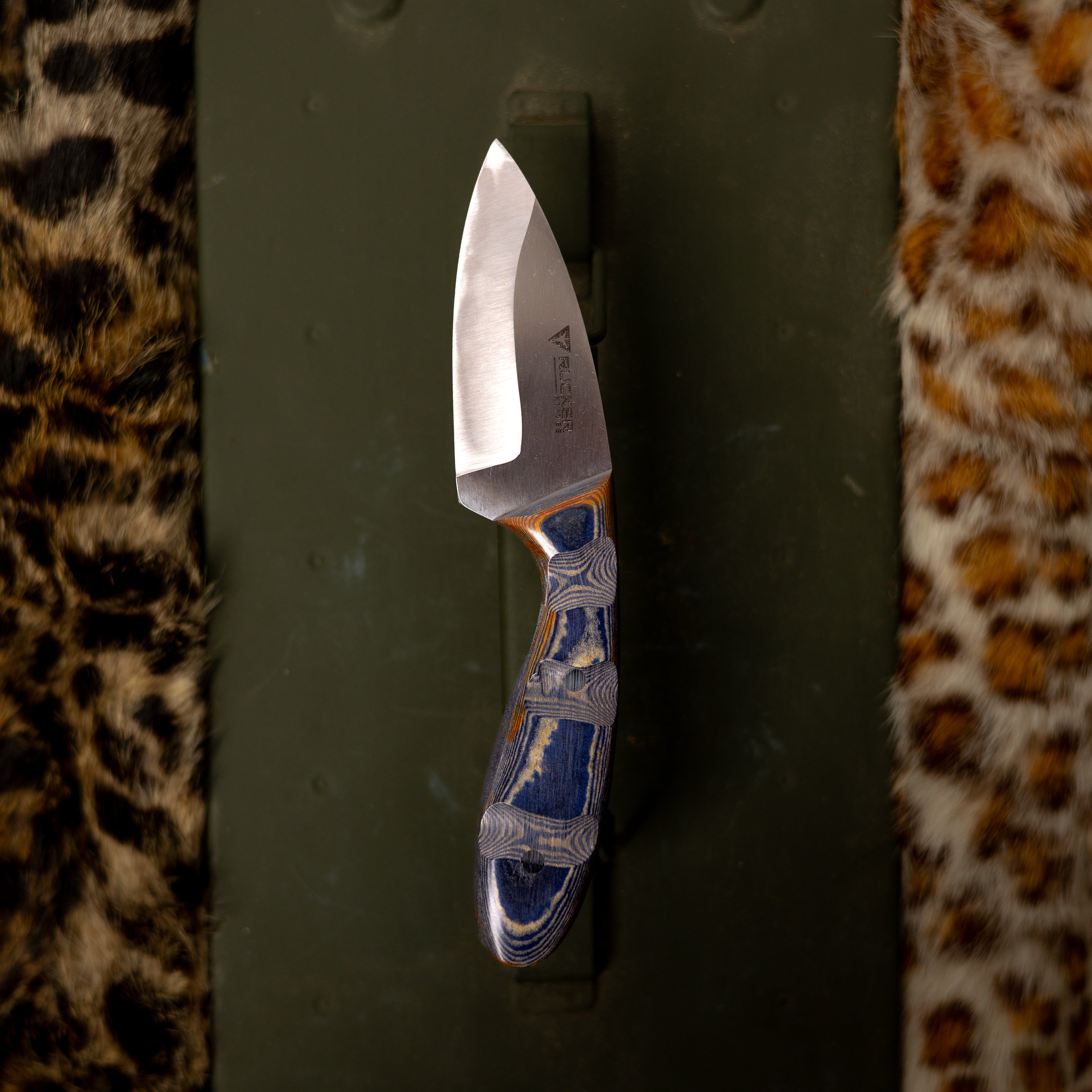 Rucker Knives Creek-Bend Knife staged background on green box and leopard fur
